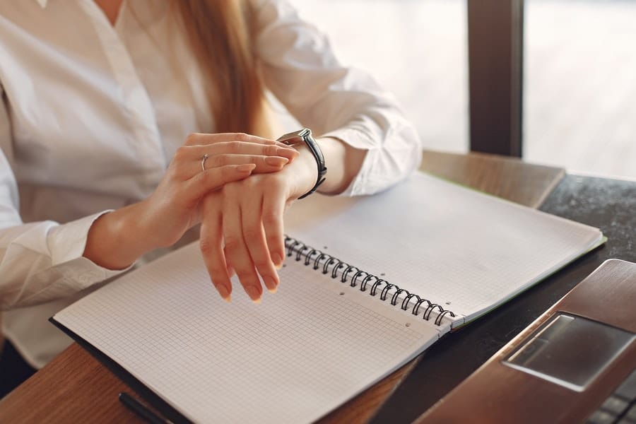 Woman checks time on her wrist watch 