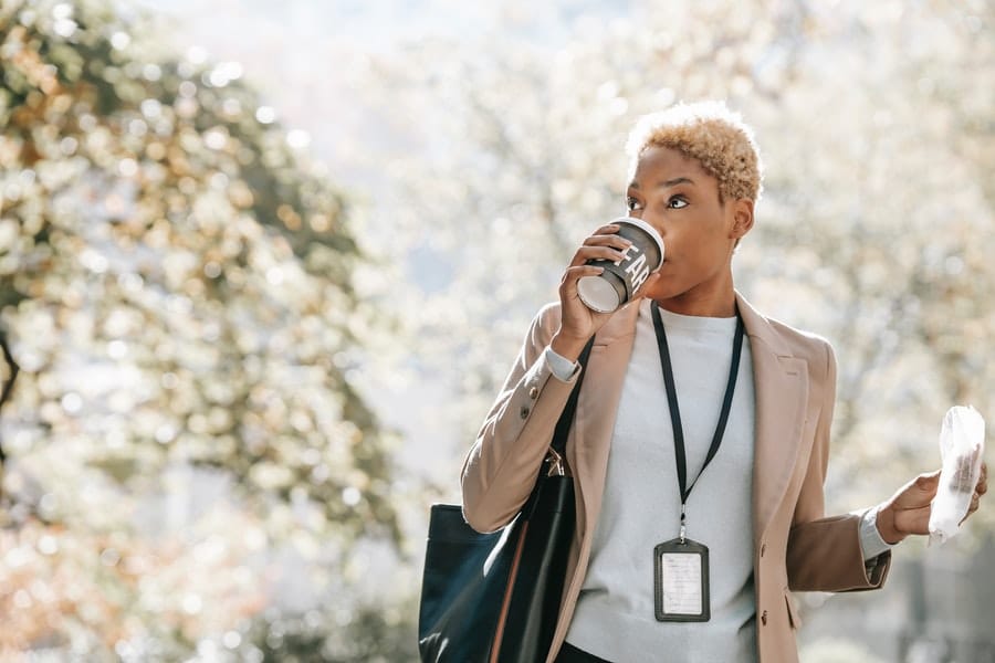 Woman drinking a coffee while walking