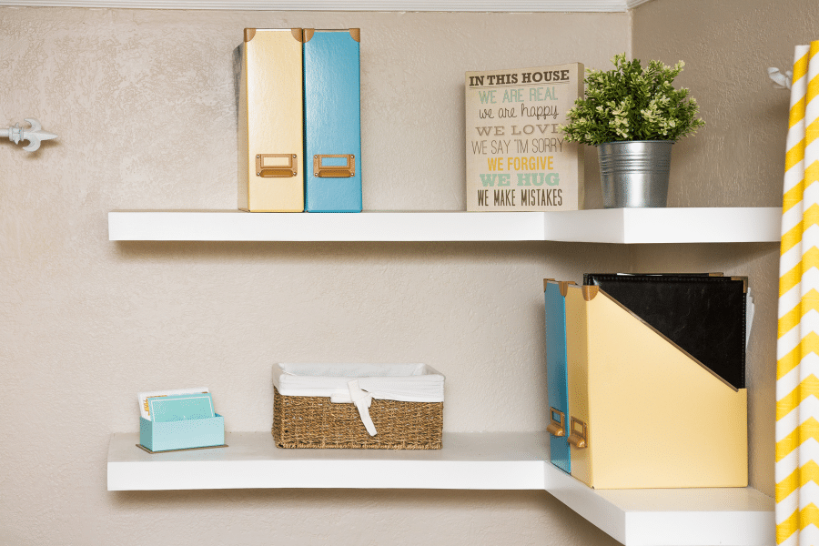 floating shelves with folder organizers and basket