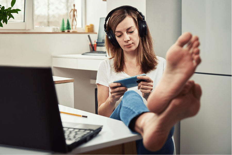 a woman playing with her gadget instead of working