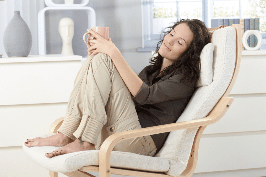 A woman relaxing on her chair holding a cup