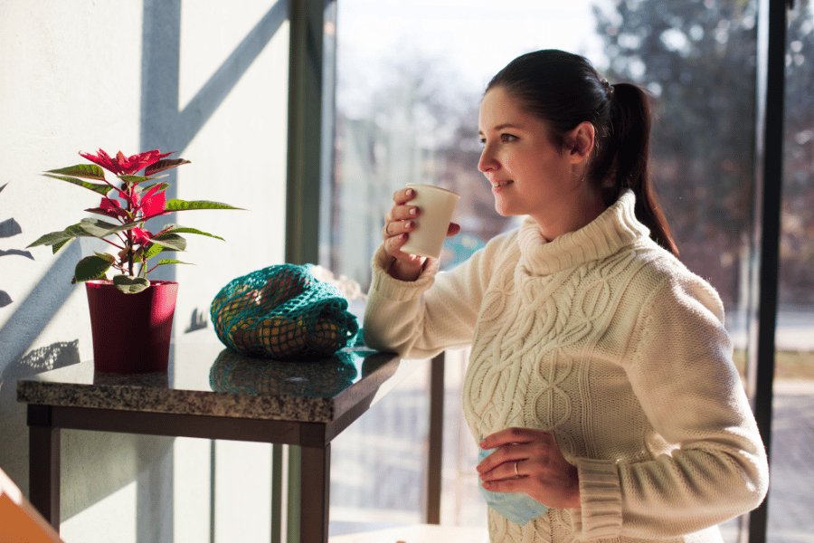 a lady having a cup of coffee