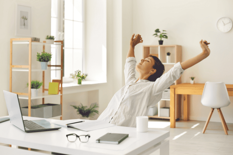 a woman stretching her arms while seated