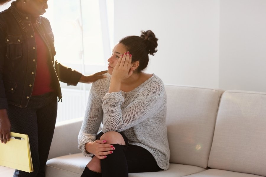 A lady comforting another lady who's stressed